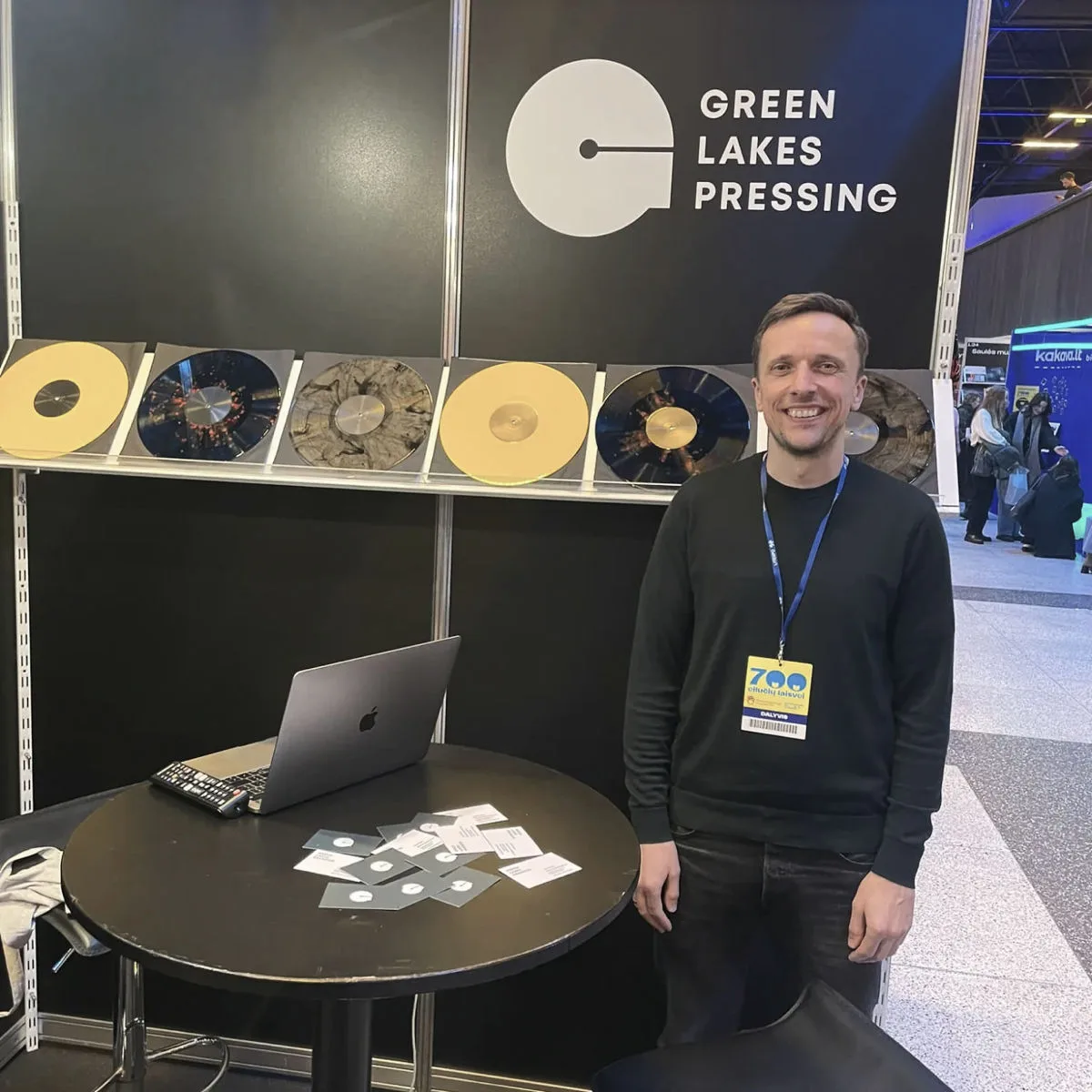 Green Lakes Pressing booth at a vinyl industry event, showcasing custom records and team presence.