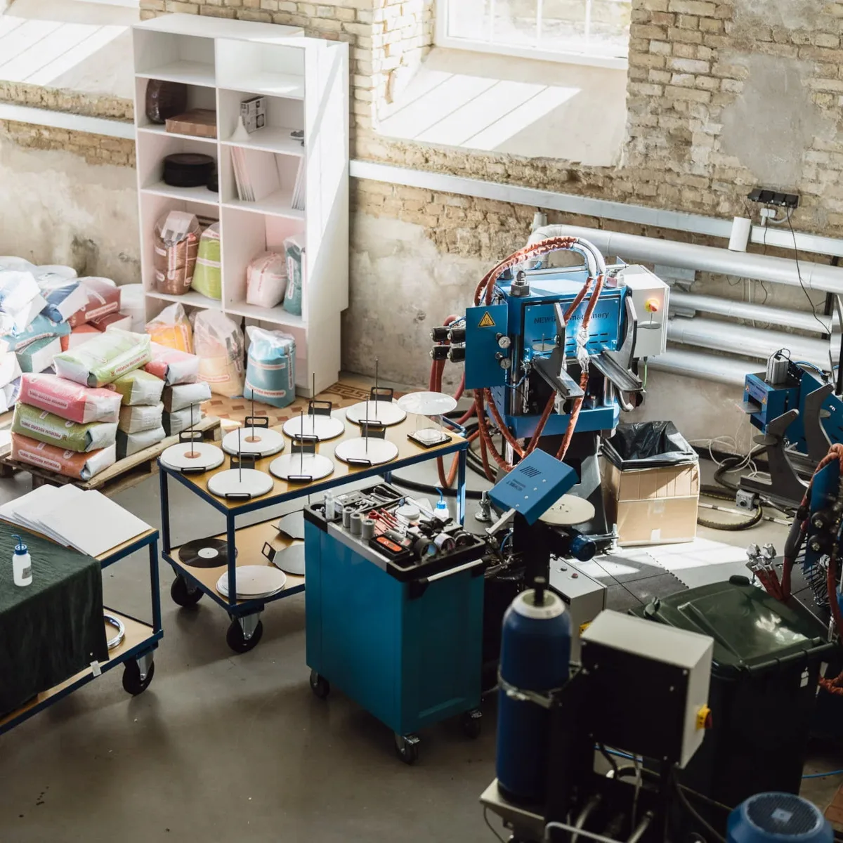 Vinyl pressing equipment and production workspace at Green Lakes Pressing in Vilnius.