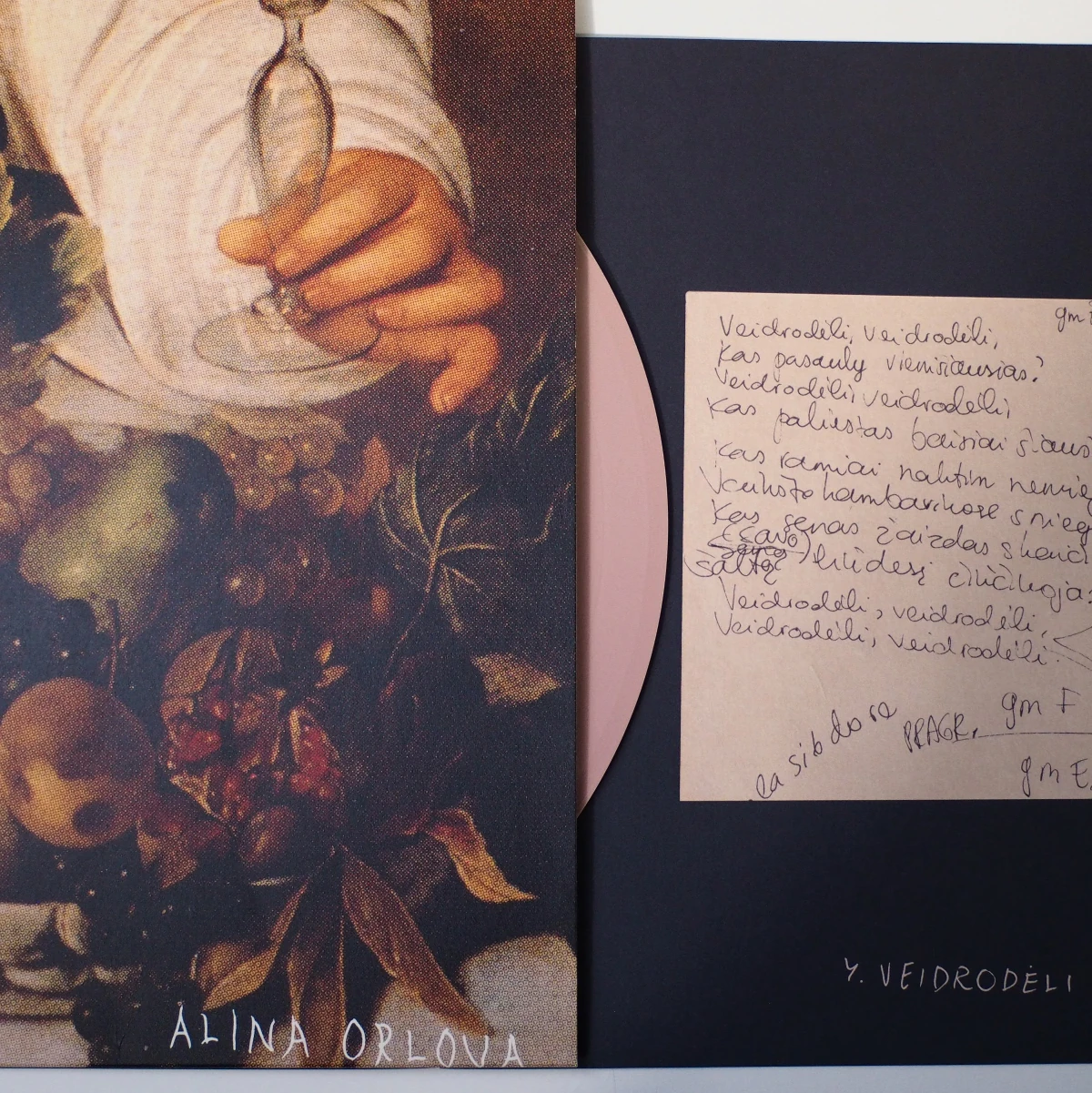 Close-up of lyrics insert and fruit-themed sleeve with pink vinyl.