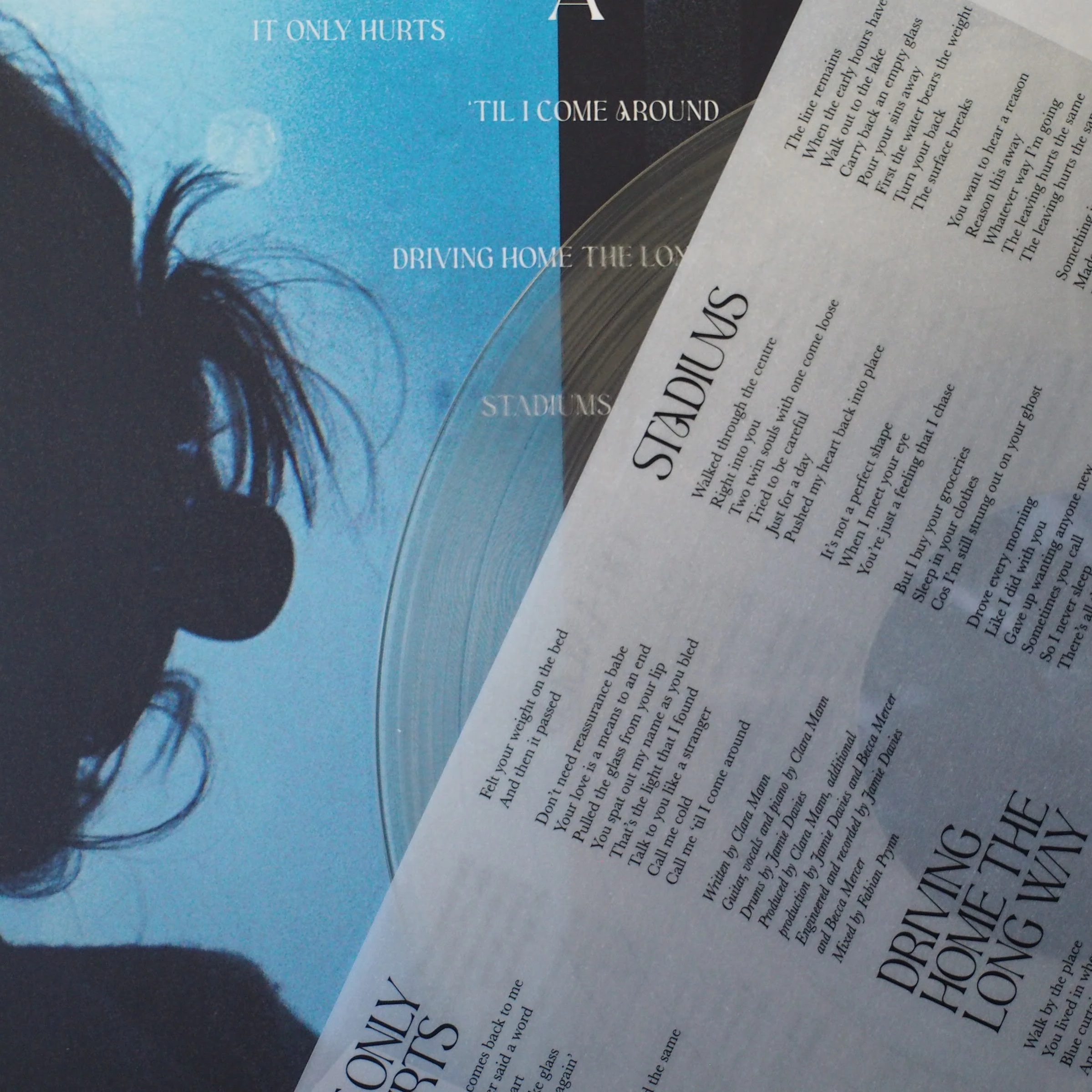 Lyrics insert showing tracklist with silhouette background from Side A.