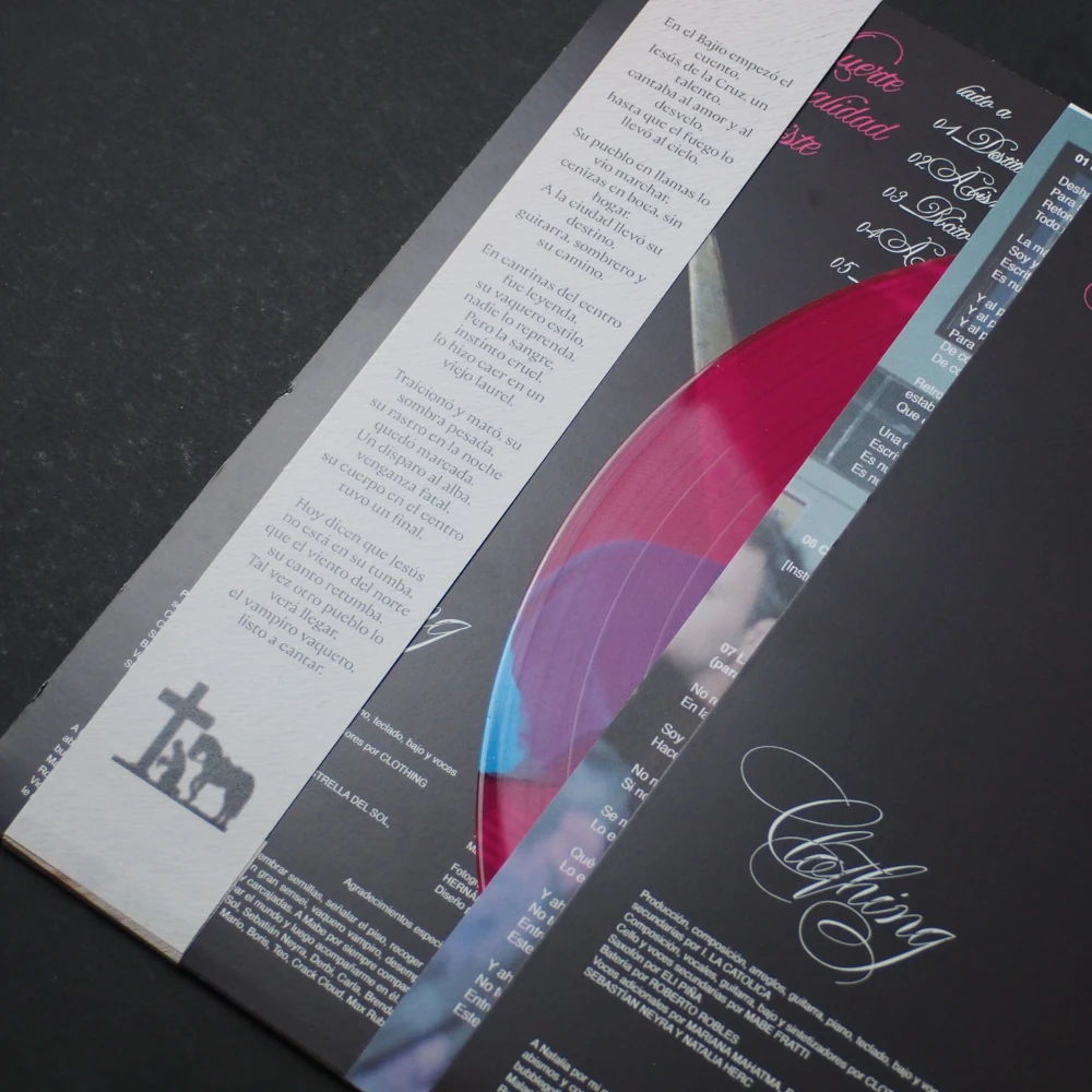 Lyric sheet and printed inner sleeve partially showing pink and blue vinyl.
