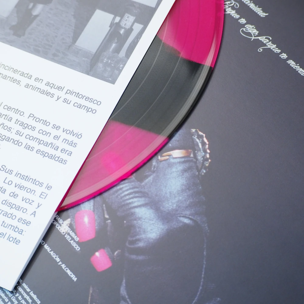 Transparent red vinyl record on a back side of a vinyl cover.