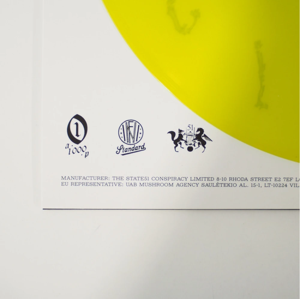 Detail shot showing vinyl edge, manufacturing credits, and label logos on printed inner sleeve.