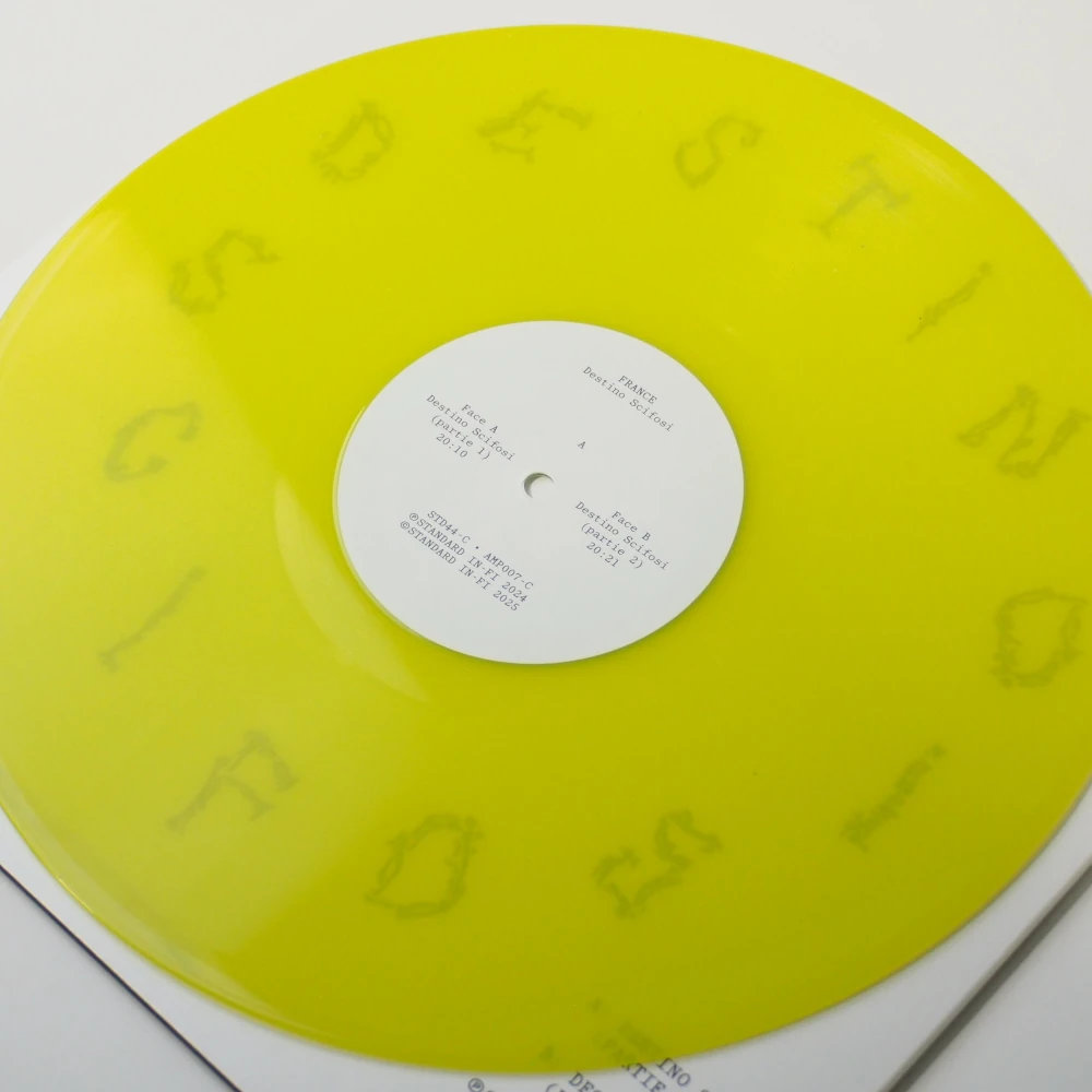 Translucent yellow vinyl record resting on back cover with black-and-white skull artwork.