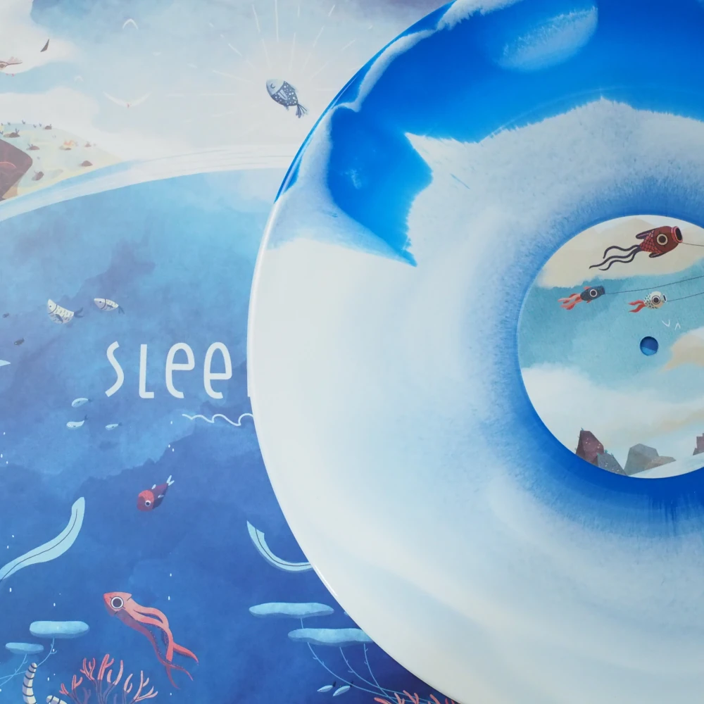 White and blue swirl vinyl on top of illustrated ocean-themed LP cover.