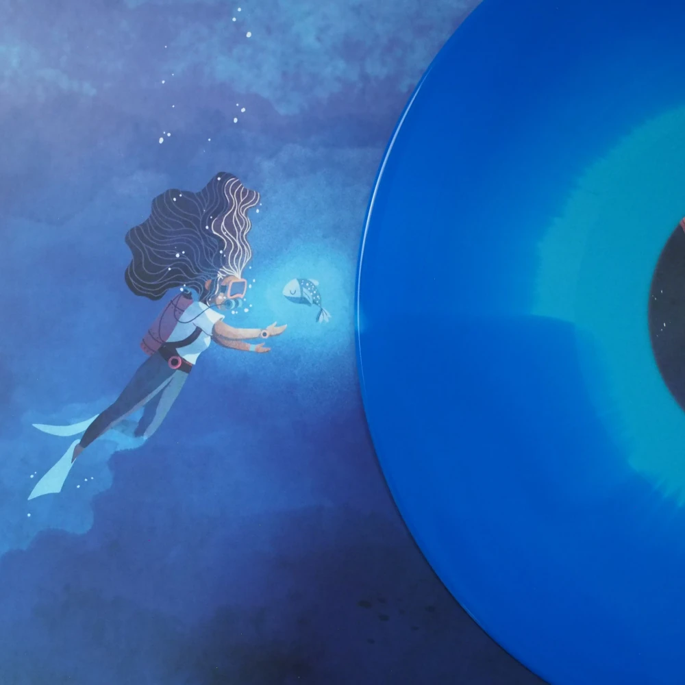 Swirl blue vinyl next to artwork showing a diver and glowing fish underwater.