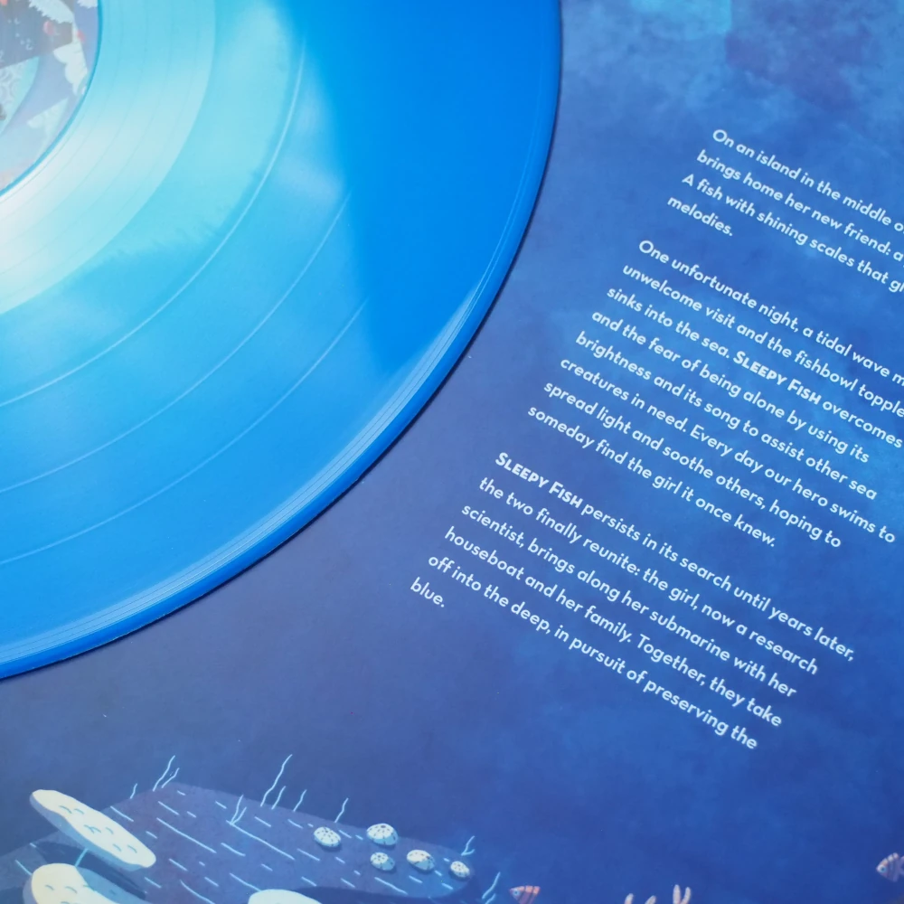 Blue swirl vinyl next to inner sleeve with narrative text and deep sea design.