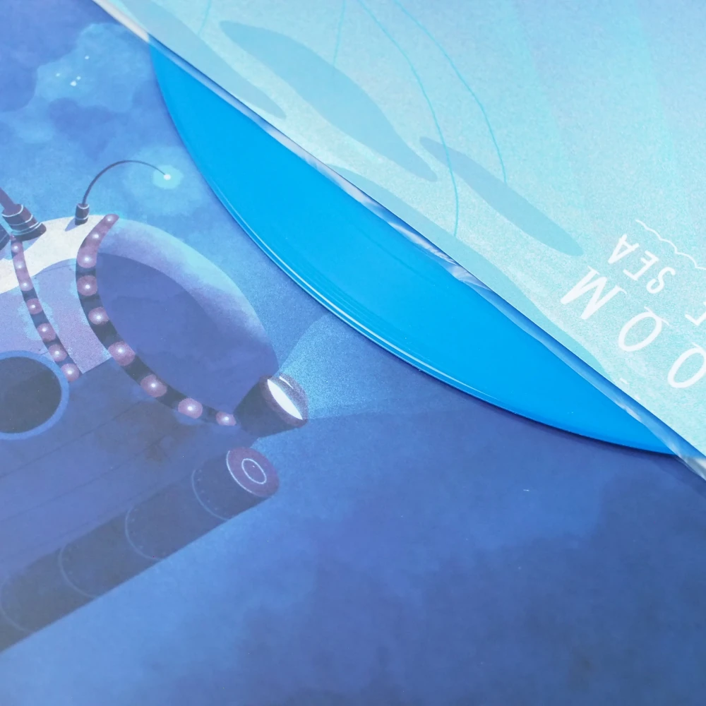 Blue vinyl record partially tucked into the printed inner sleeve with submarine illustration.