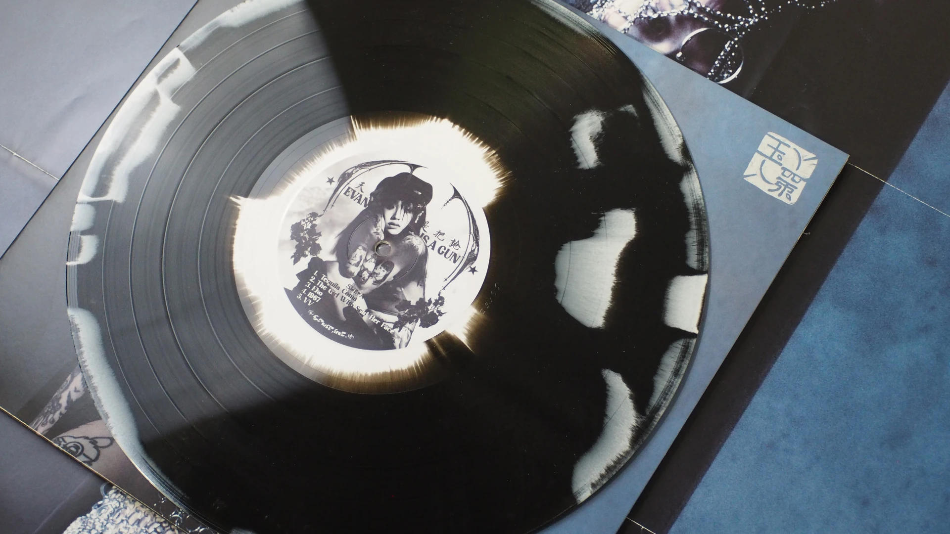 Side A of Yeule’s Evangelic Girl Is A Gun vinyl with custom center label and black & white splatter pattern.