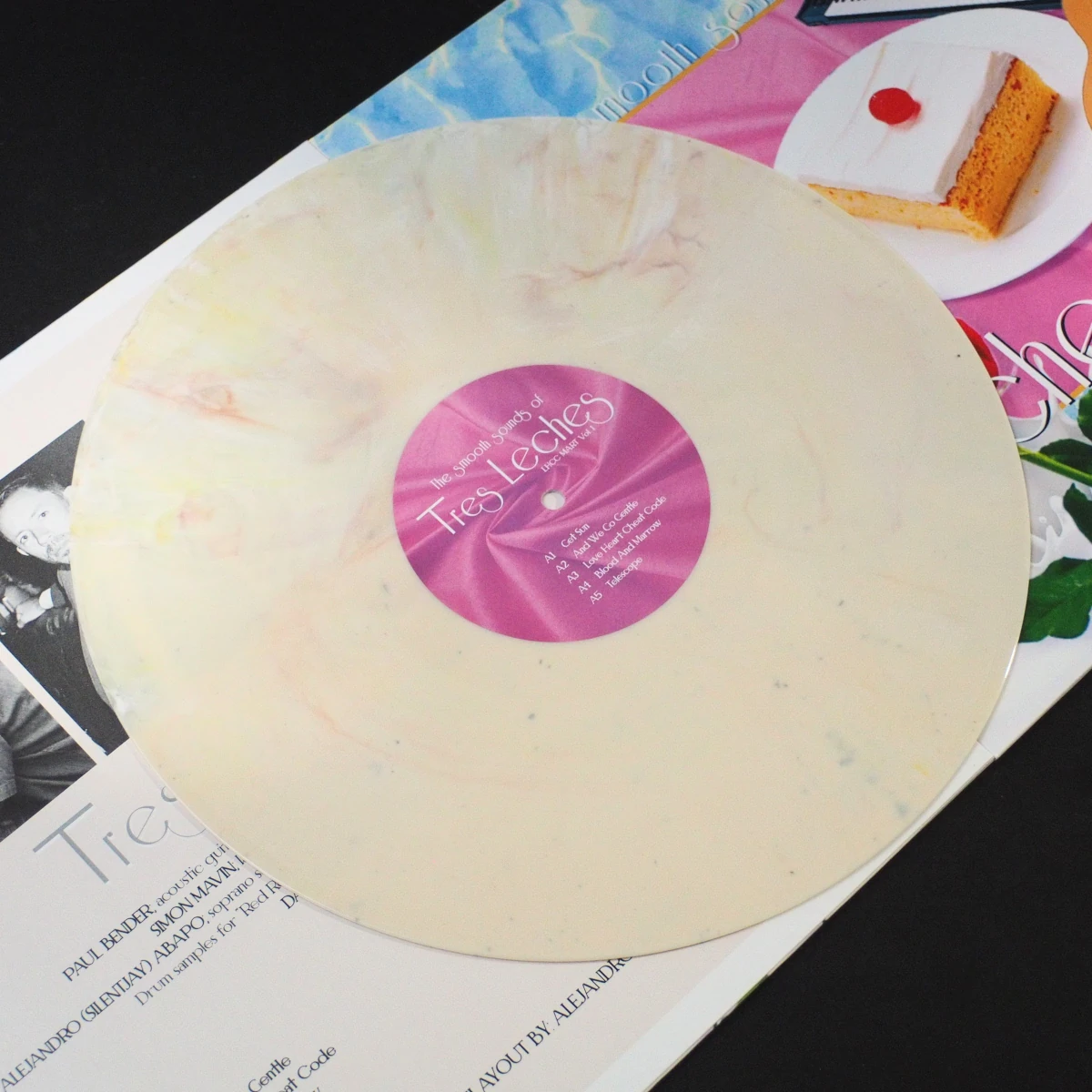 Cream marble vinyl record of Tres Leches album.