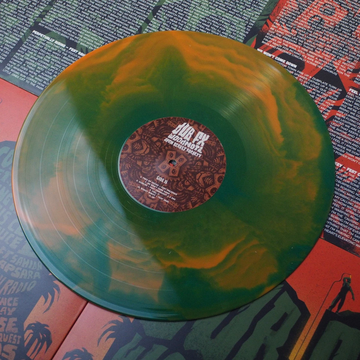 Vinyl laid flat on top of printed inner sleeves with lyrics and credits.